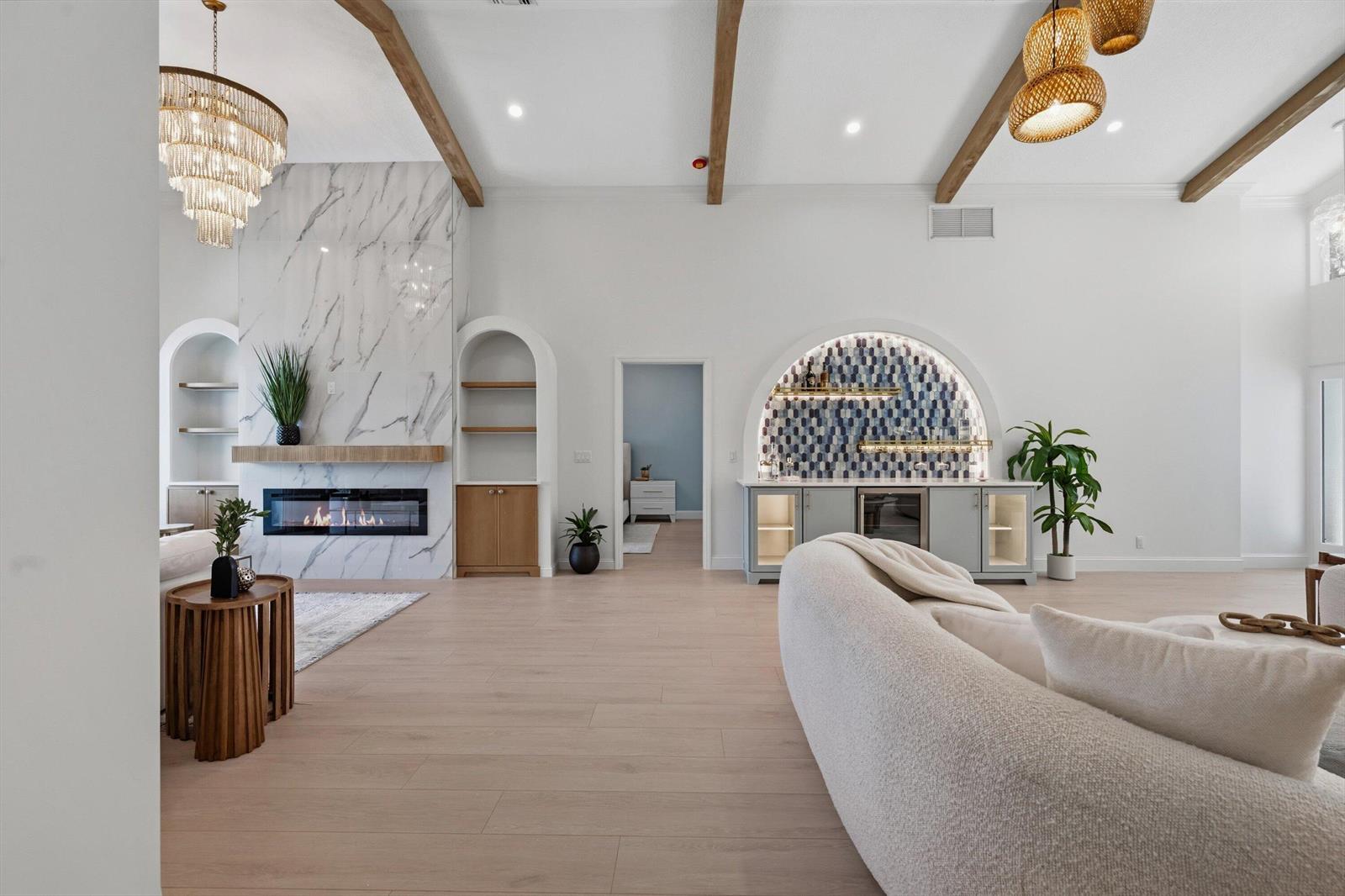 A living room features a marble fireplace, a built-in bar, and exposed wooden ceiling beams — 17104 Crossgate Drive, Jupiter FL 33477, JUPITER, FL