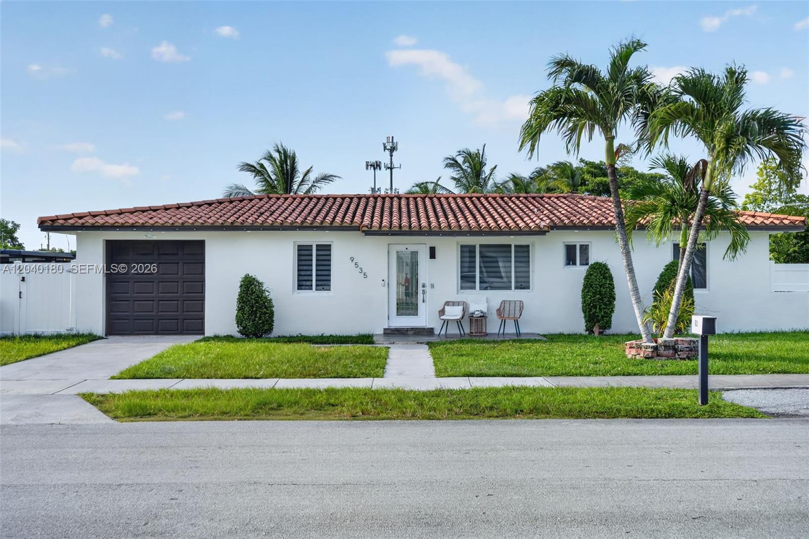 A single-story white house features a brown tiled roof, a garage, and two palm trees — 9535 SW 42nd St, Miami FL 33165, MIAMI, FL