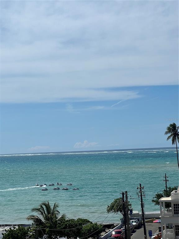 An elevated view of the ocean with several jet skis and a palm tree — 16 AMAPOLA UNIT 504, CAROLINA, PR
