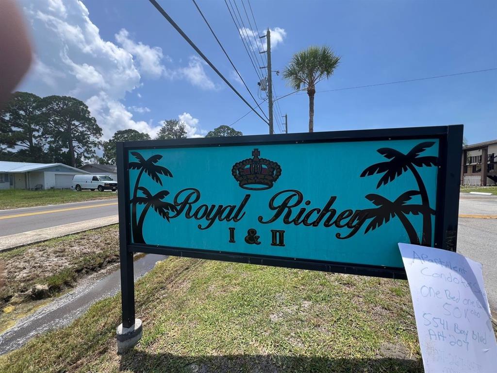 A teal sign for Royal Richey I & II stands outdoors near a road — 5541 BAY BOULEVARD UNIT 107, PORT RICHEY, FL