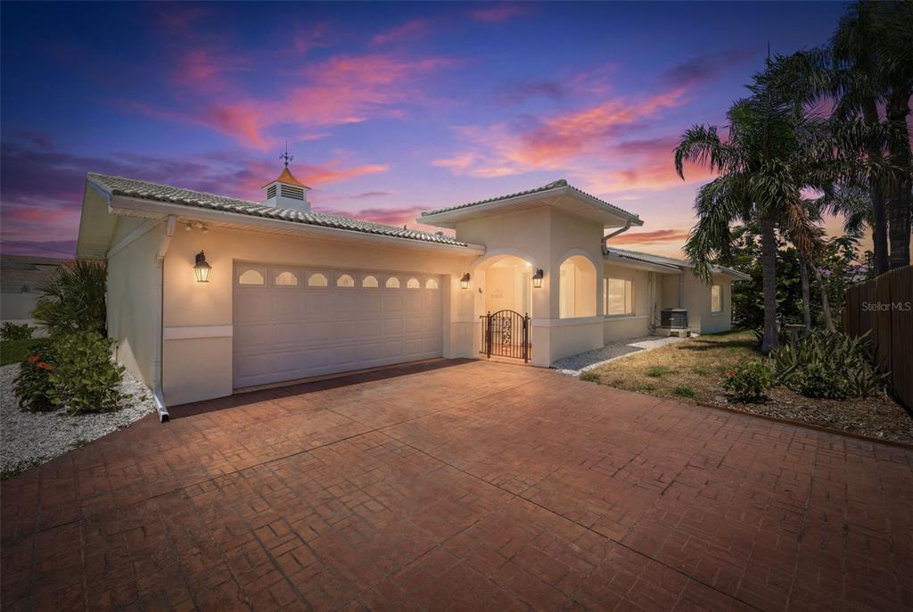 A single-story house with a two-car garage, a gated entryway, and a paved driveway — 3666 BELLE VISTA DRIVE E, ST PETERSBURG, FL