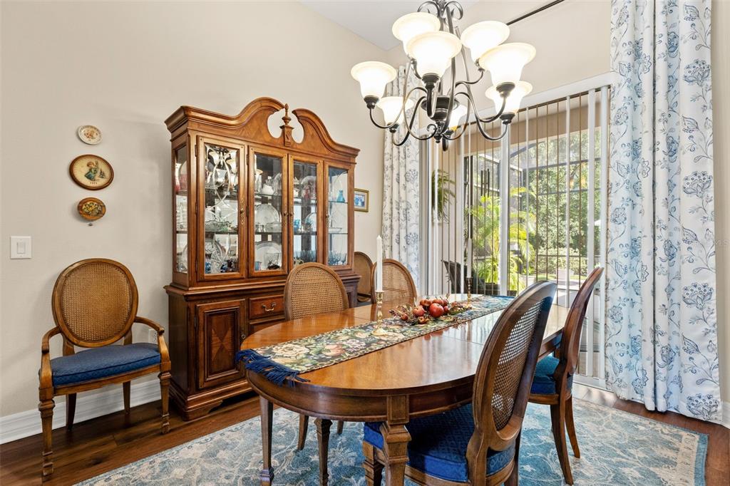 A view from an entryway into a living room with hardwood floors and blue furniture — 15103 AZRA DRIVE, ODESSA, FL