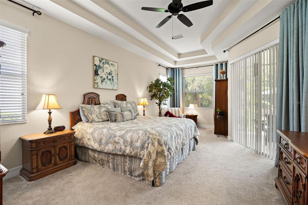A kitchen features dark wood cabinets, granite countertops, a center island, and tile flooring — 15103 AZRA DRIVE, ODESSA, FL