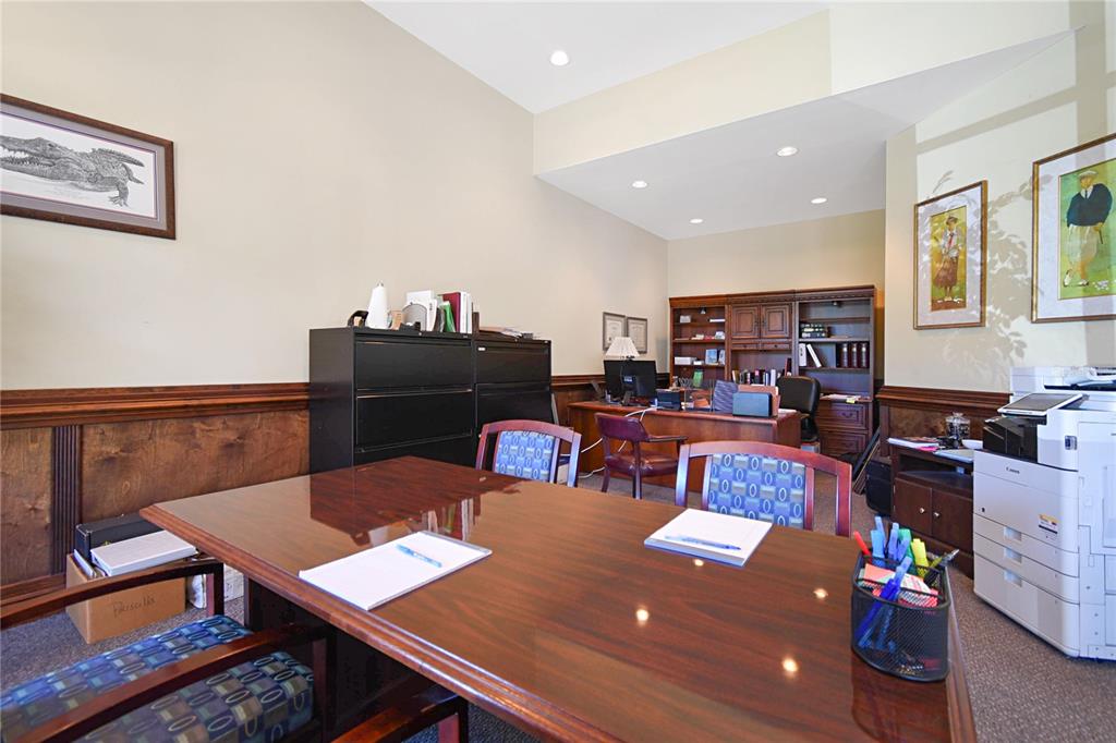 An office with a large wooden desk, chairs, filing cabinets, and wood wainscoting — 1301 PLANTATION ISLAND DRIVE S UNIT 303A, ST AUGUSTINE, FL