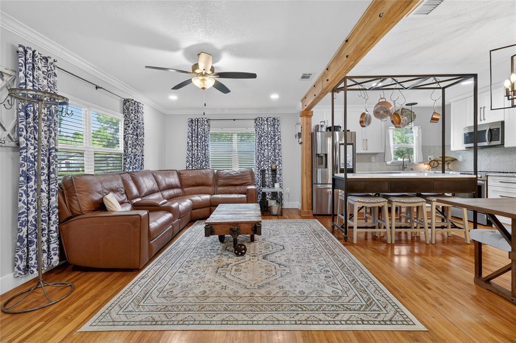 A living room with a leather sectional, area rug, and an open kitchen with island — 1570 IMPERIAL AVENUE, BARTOW, FL