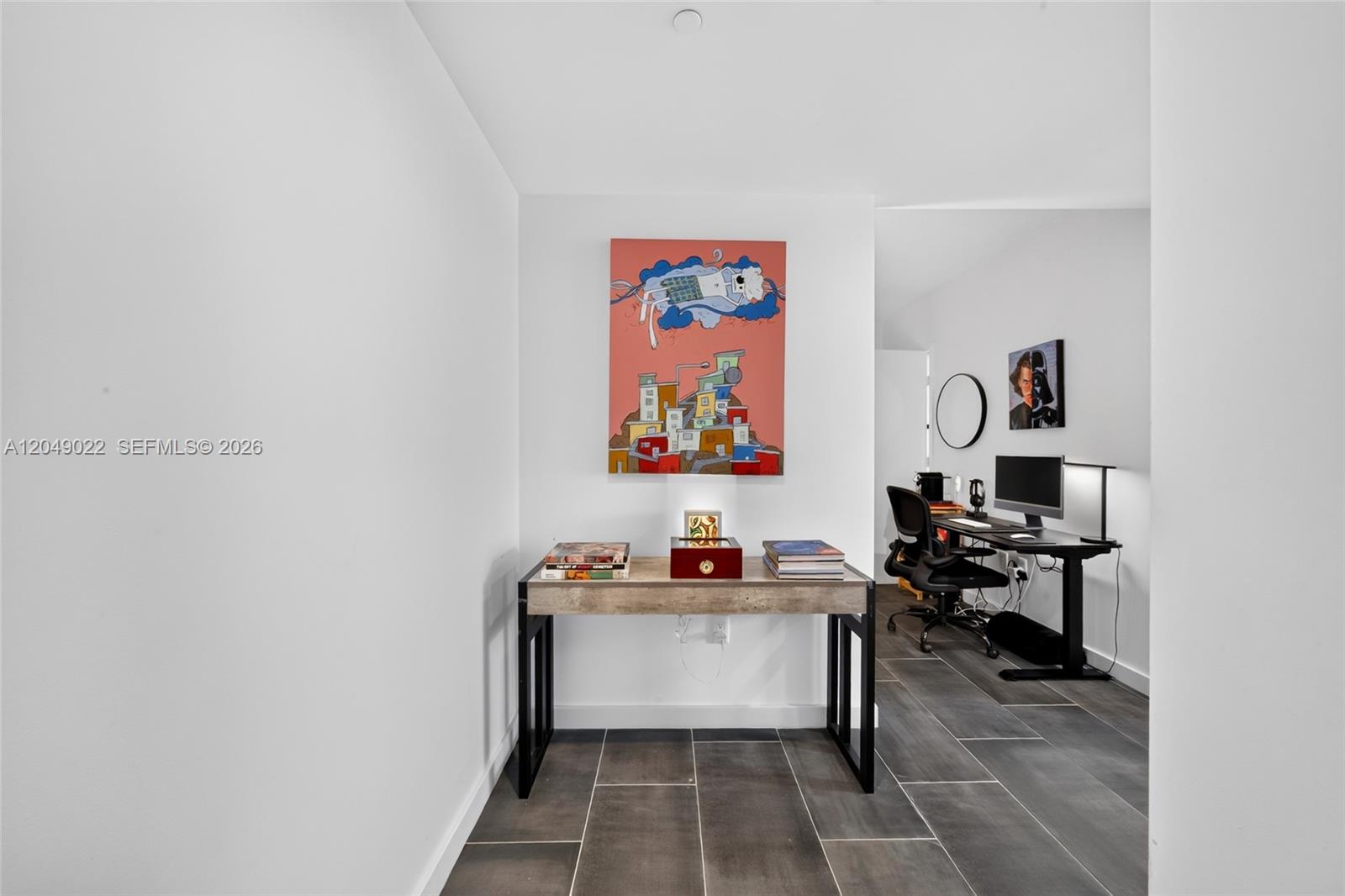 A hallway features a console table with artwork above, leading to a home office area — 1100 S Miami Ave # 1603, Miami FL 33130, MIAMI, FL