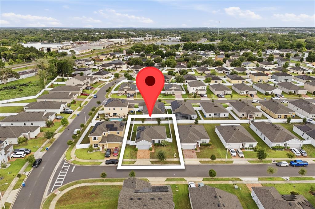 An aerial view shows a single-family house with a fenced backyard and a red pin — 541 WILDCAT LANE, DAVENPORT, FL