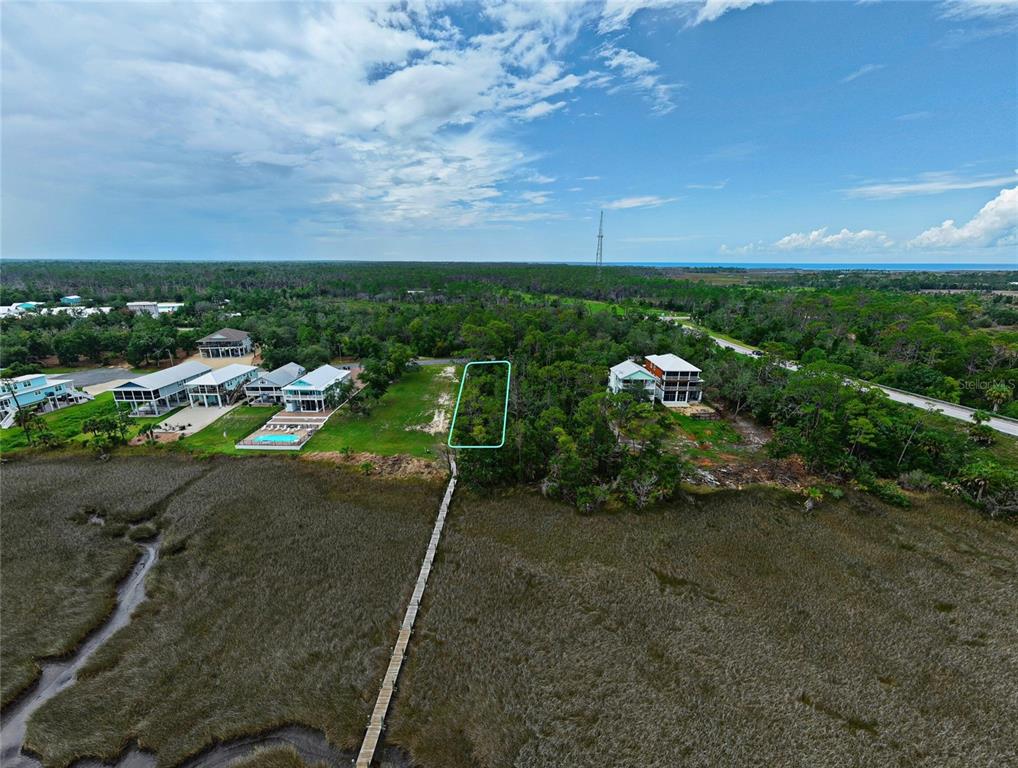 An aerial view shows a vacant lot outlined in green near a coastal marshland — 85 SW 279TH AVENUE, STEINHATCHEE, FL