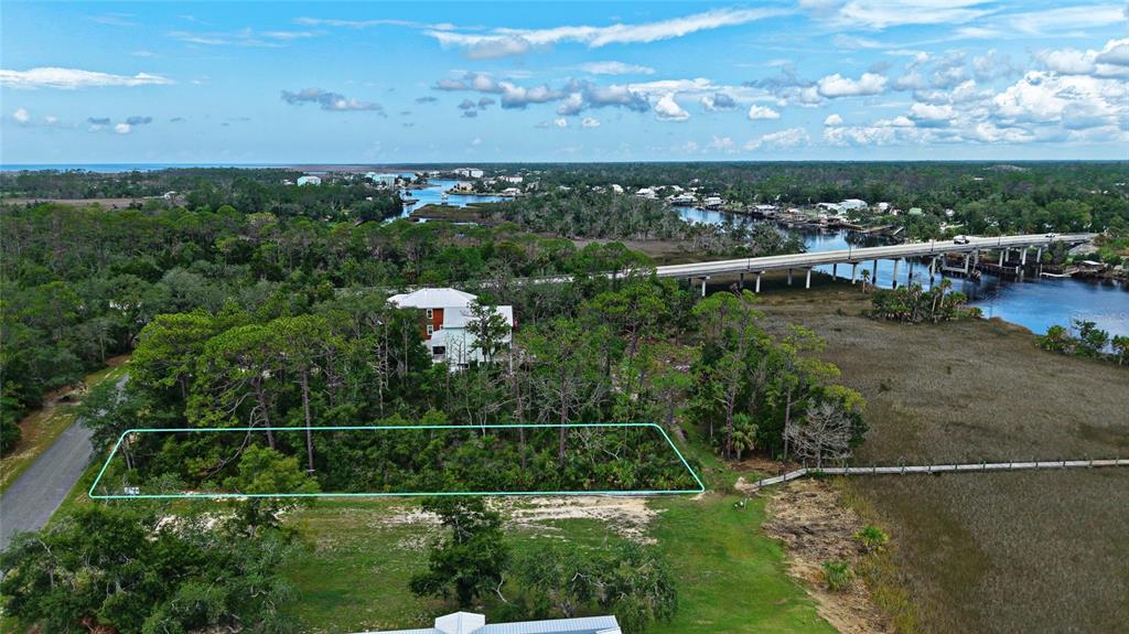 An aerial view shows a rectangular plot of land outlined in blue near a waterway — 85 SW 279TH AVENUE, STEINHATCHEE, FL