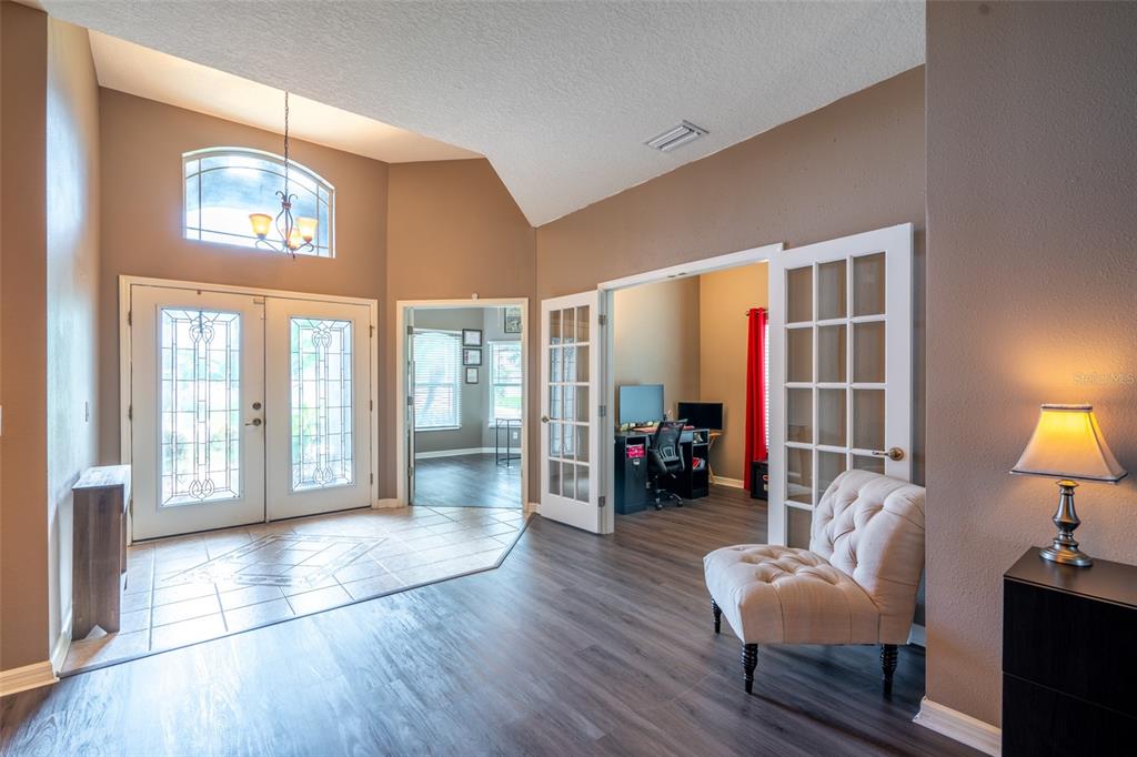An entryway with tile flooring, a vaulted ceiling, and French doors leading to an office — 1809 BONITA BLUFF COURT, RUSKIN, FL
