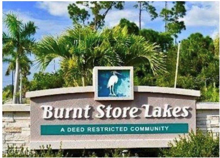 The entrance sign for the Burnt Store Lakes community features a white bird illustration — 16791 SAN EDMUNDO ROAD, PUNTA GORDA, FL