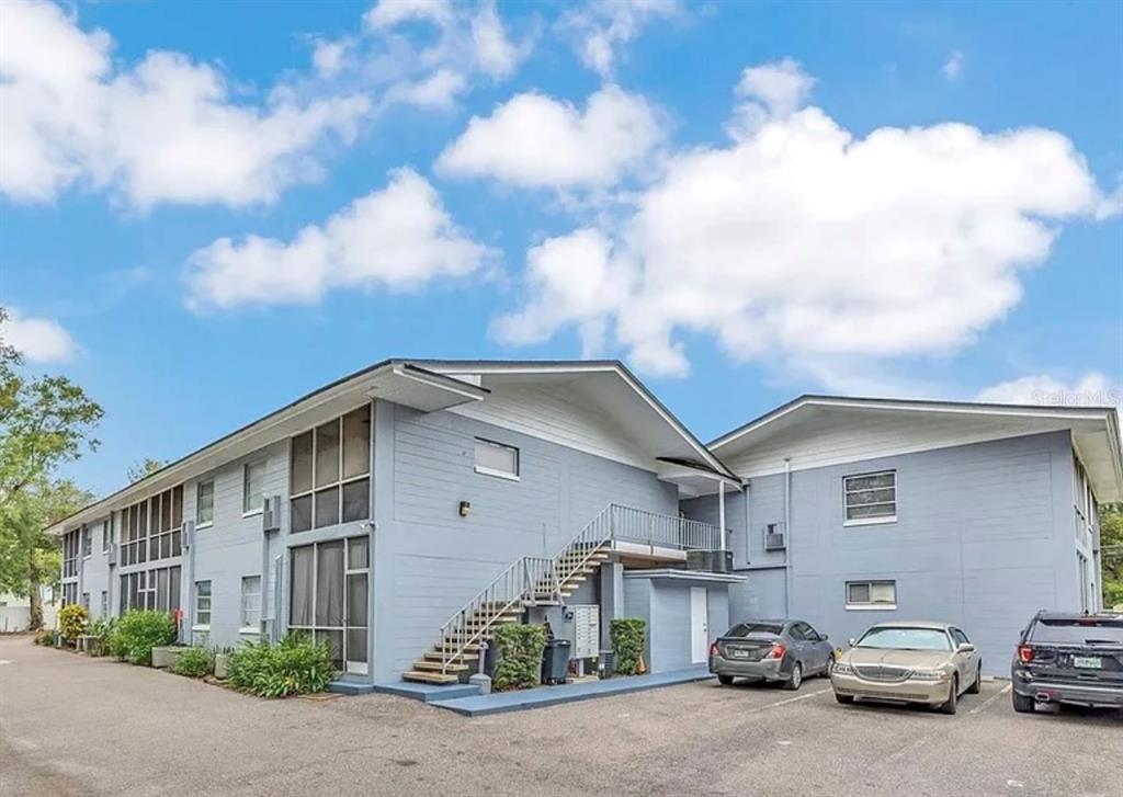 A two-story blue apartment building with an exterior staircase and a parking lot in front — 1014 E SOUTH STREET UNIT 16, ORLANDO, FL