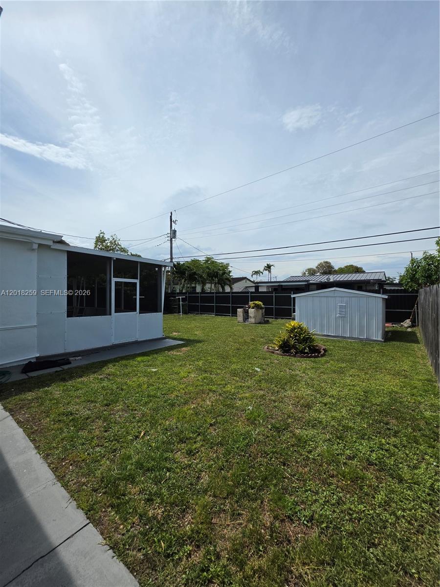A backyard features a screened-in patio, a metal storage shed, and a small garden bed — 4601 SW 5th St # 0, Miami FL 33134, MIAMI, FL