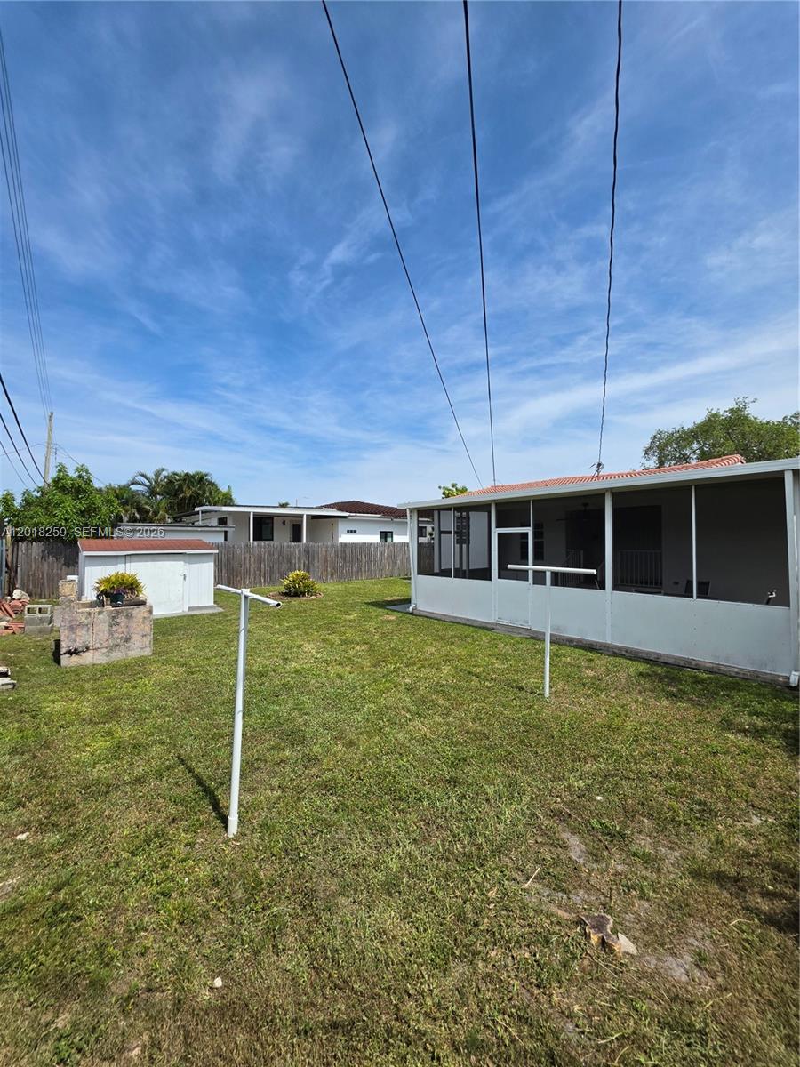 A backyard features a screened-in patio, a small storage shed, and two clothesline poles — 4601 SW 5th St # 0, Miami FL 33134, MIAMI, FL