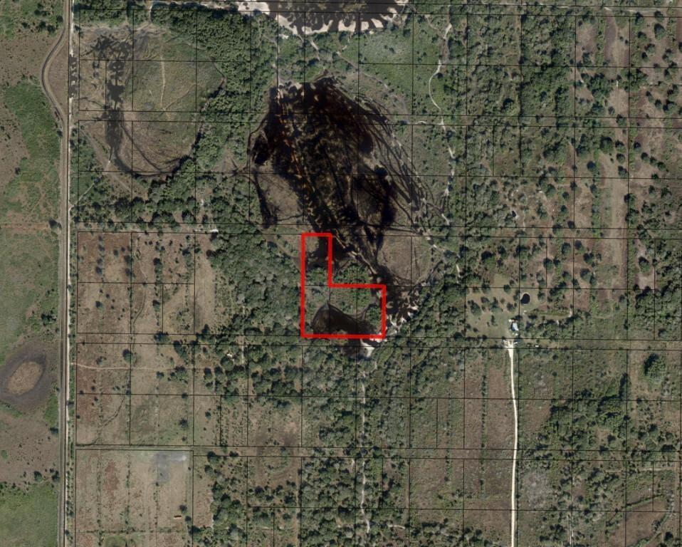 An aerial map shows a red-outlined parcel of land featuring wooded areas and dark ponds — 0 NW 296th Street, Okeechobee FL 34972, OKEECHOBEE, FL
