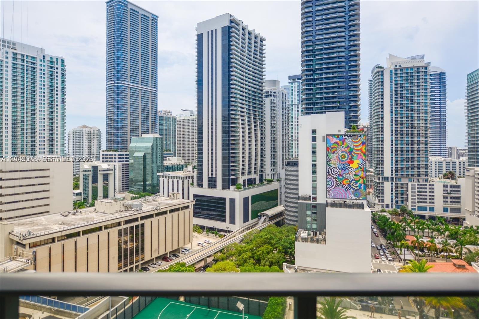 An elevated view of a dense urban skyline featuring modern skyscrapers and a monorail track — 801 S Miami Ave # 1702, Miami FL 33130, MIAMI, FL