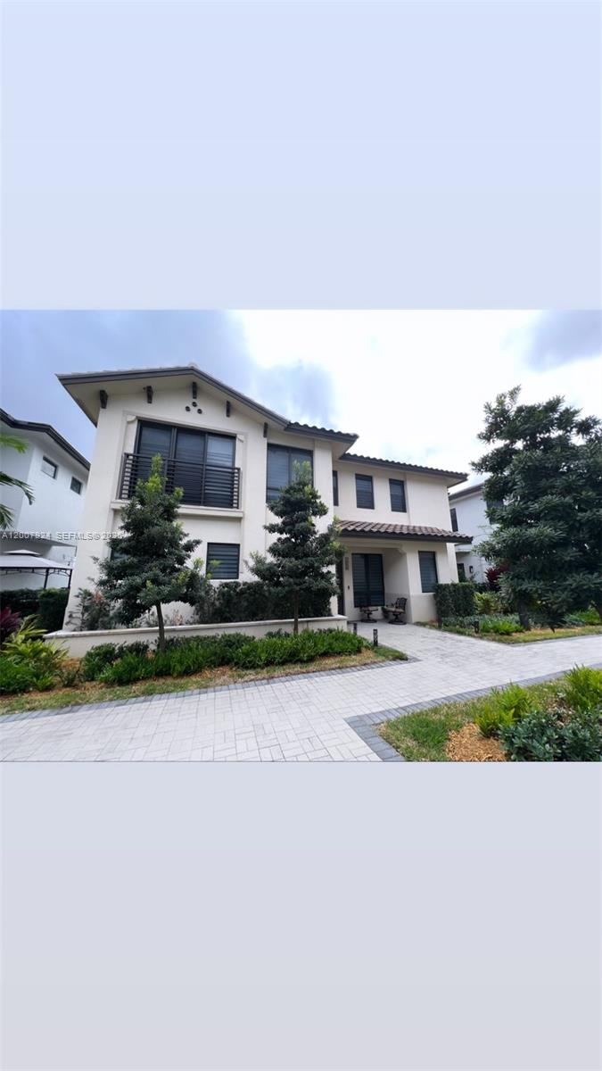 A two-story house with a beige exterior, a tiled roof, and a paved driveway — 8253 NW 47th Ln, Doral FL 33166, DORAL, FL