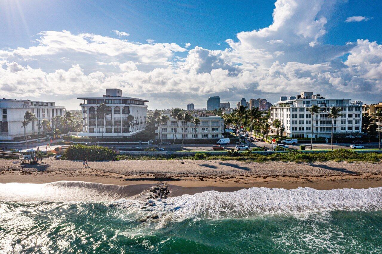An aerial view of a sandy beach with ocean waves and nearby multi-story buildings — 350 S Ocean Boulevard # 201, Palm Beach FL 33480, PALM BEACH, FL