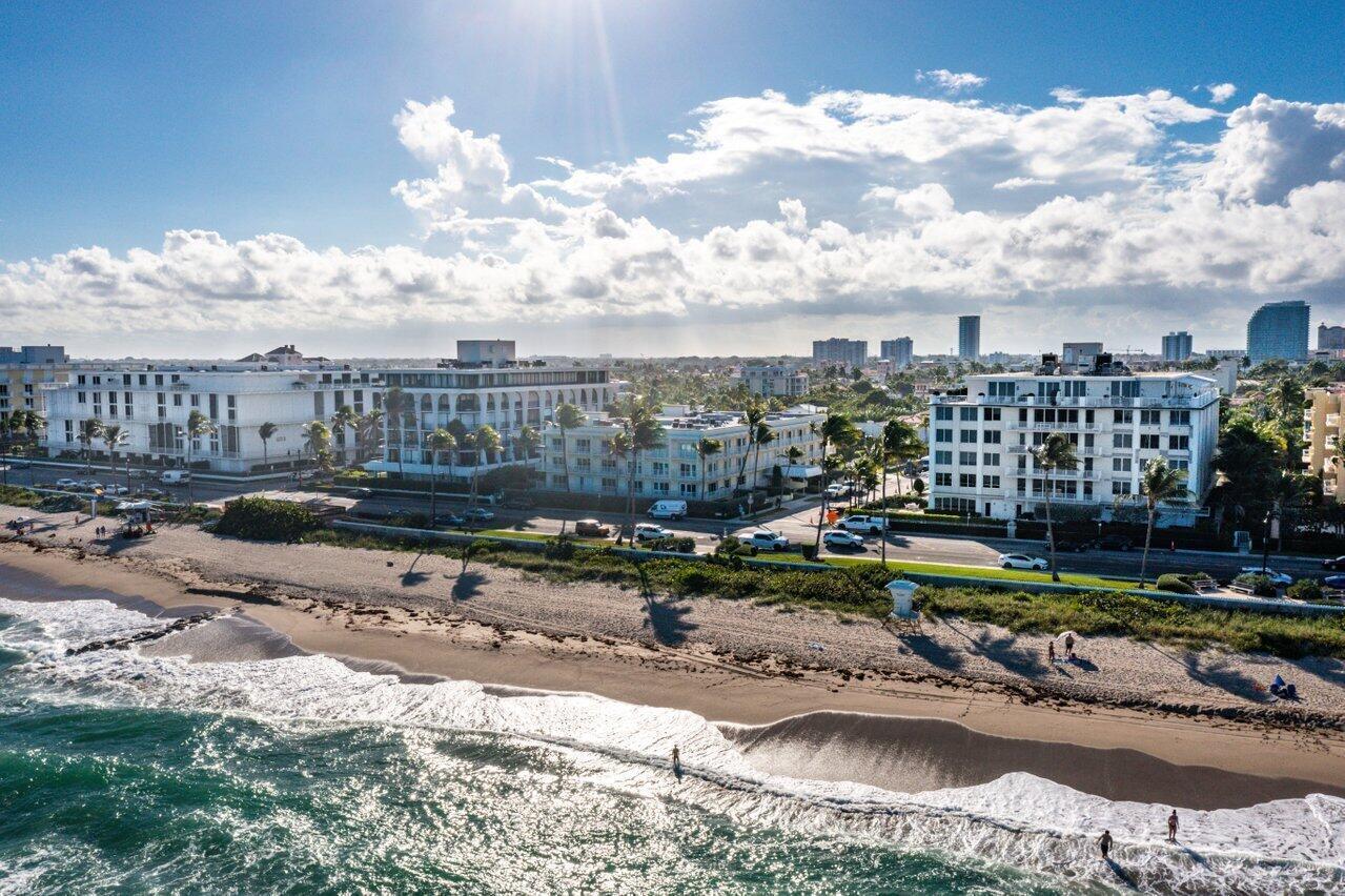 An aerial view of a sandy beach with ocean waves and multi-story residential buildings nearby — 350 S Ocean Boulevard # 201, Palm Beach FL 33480, PALM BEACH, FL