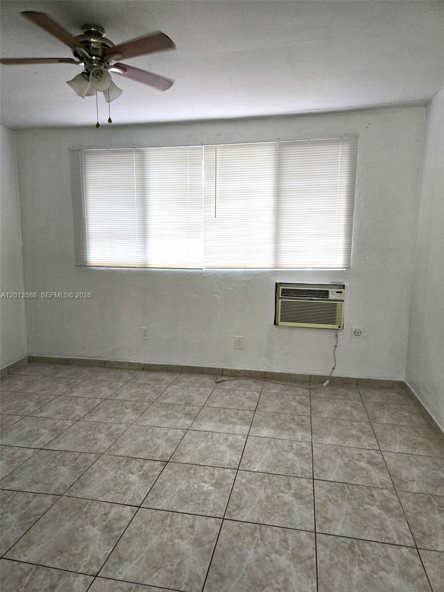 A room with white walls, tiled flooring, a ceiling fan, and a window air conditioner — 4610 SW 40th St # 1, West Park FL 33023, WEST PARK, FL
