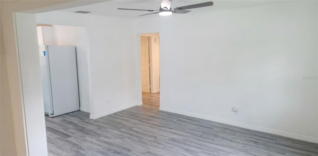A room with white walls, light gray wood-look flooring, and a ceiling fan — 1412 LAUREL STREET, PALATKA, FL