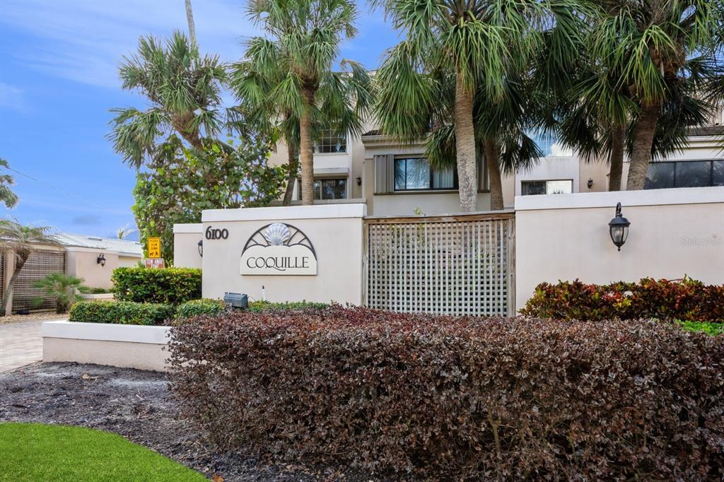 A sign for Coquille stands in front of a building surrounded by palm trees — 1195 COQUILLE STREET UNIT 309, SARASOTA, FL