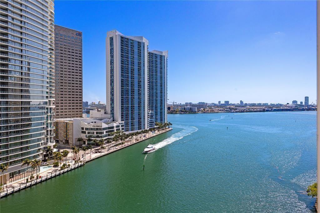An elevated view of a coastal city skyline featuring high-rise buildings, a bridge, and water — 465 Brickell Avenue # 2706, Miami FL 33131, MIAMI, FL