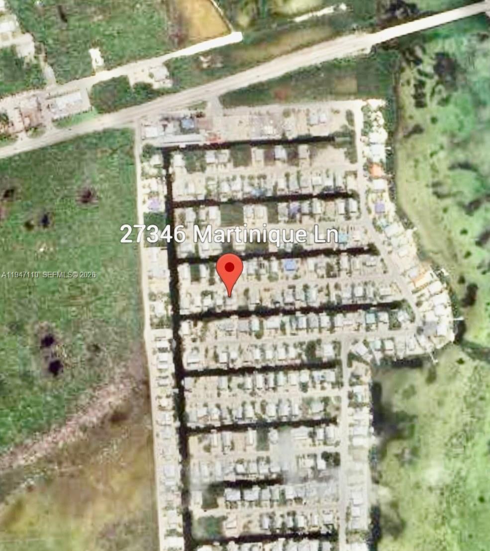 This is an aerial map view of a residential neighborhood with a red location pin — 27346 Martinique Ln # 27346, Middle Keys FL 33042, MIDDLE KEYS, FL