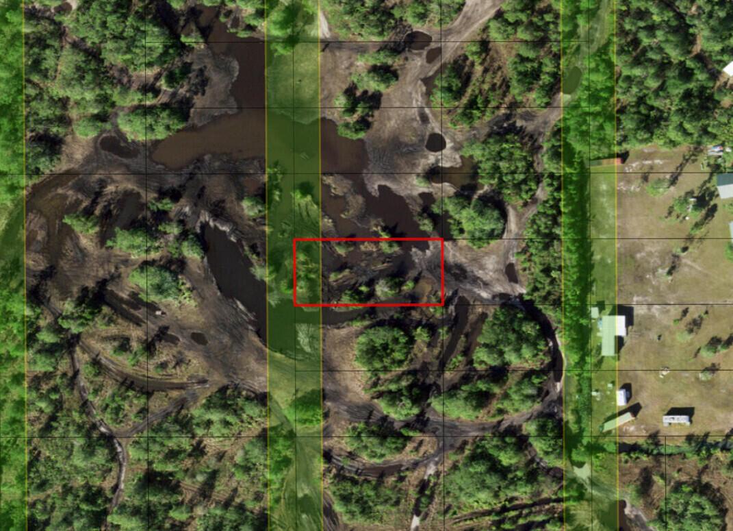 This aerial map shows a wooded, muddy lot with a red rectangle highlighting a section — 0 Holopaw Groves Road, FL 34772, FL