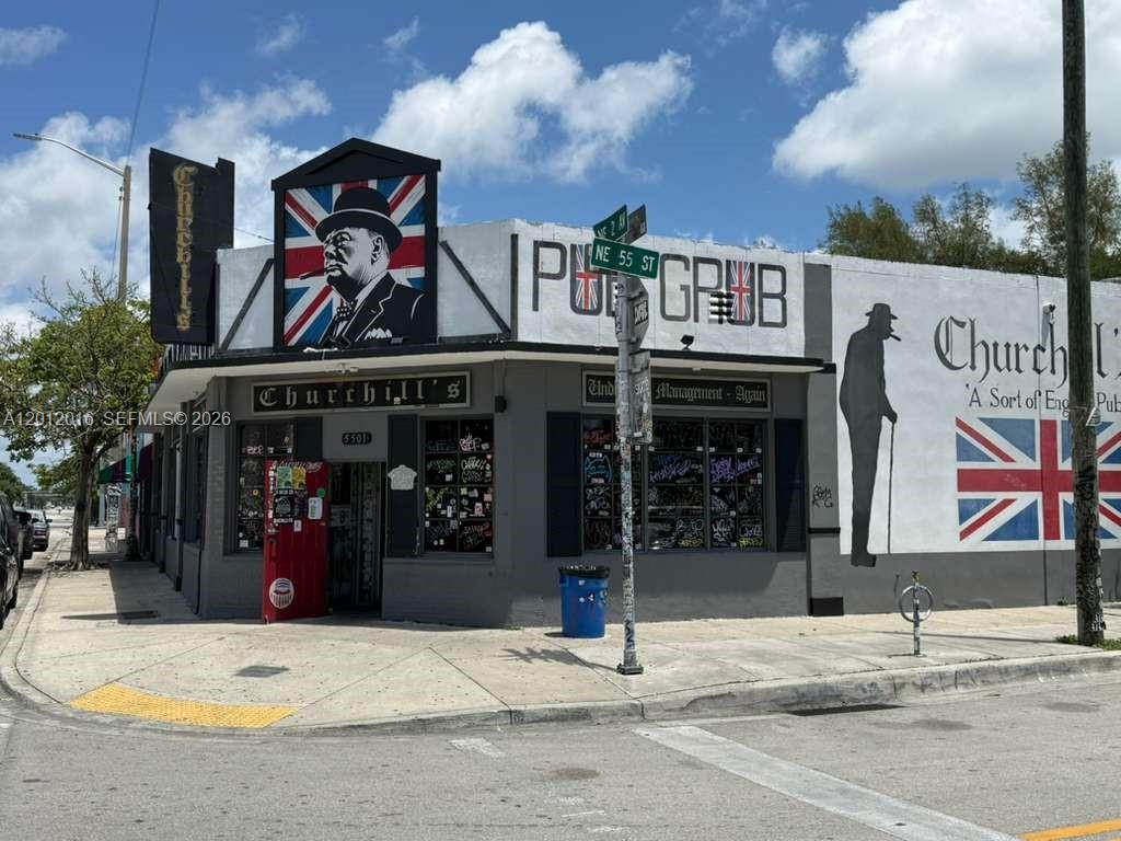 The exterior of a corner building features a mural of Winston Churchill and British flags — 285 NE 55th St, Miami FL 33137, MIAMI, FL
