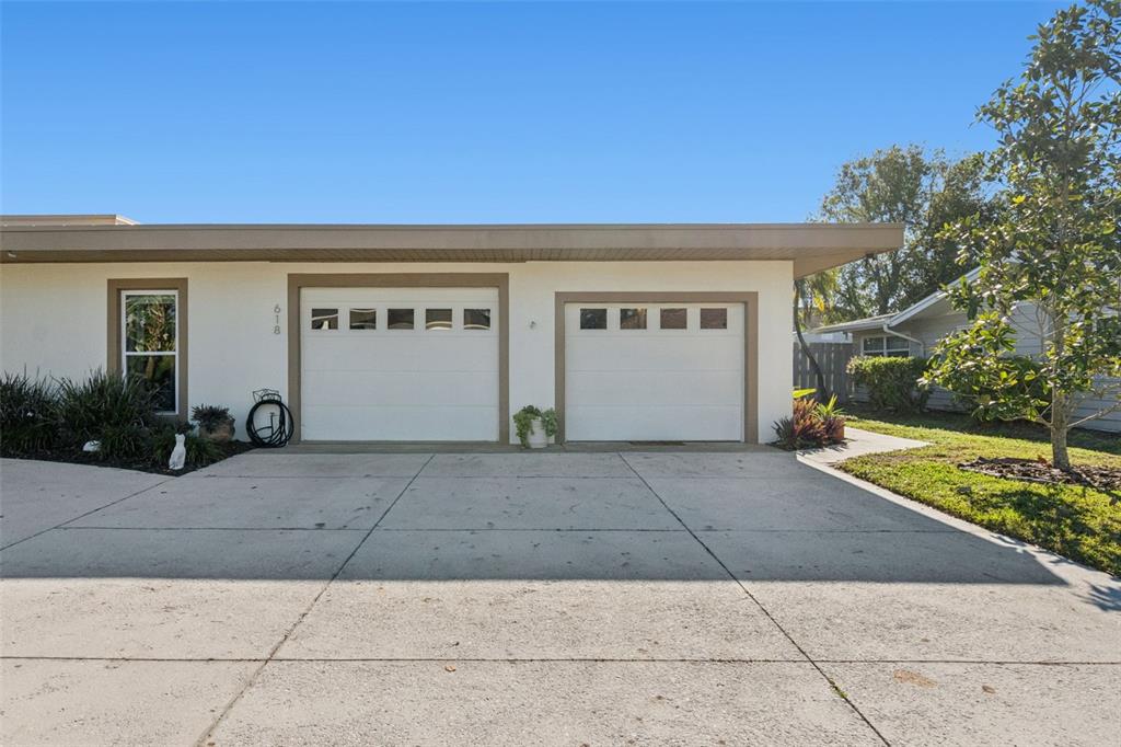 The exterior of a house features a two-car garage, a single window, and a driveway — 618 WHITFIELD AVENUE, SARASOTA, FL