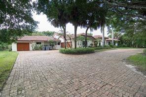A brick driveway leads to a single-story house with a tiled roof and palm trees — 8208 Twin Lake Drive, Boca Raton FL 33496, BOCA RATON, FL