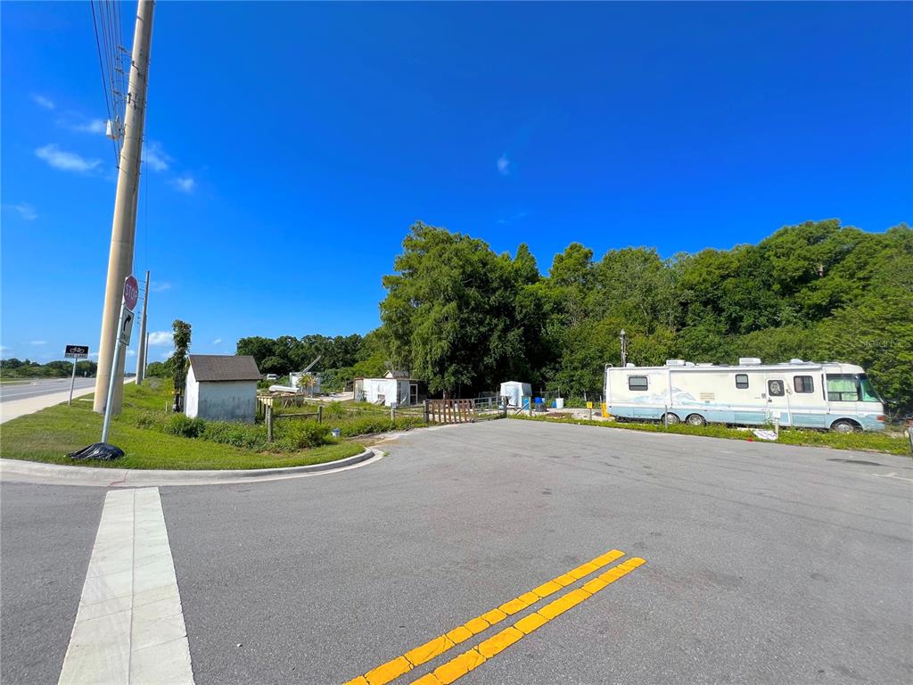 An outdoor view of a paved road, a utility pole, and a recreational vehicle on land — 200 N HOAGLAND BOULEVARD, KISSIMMEE, FL