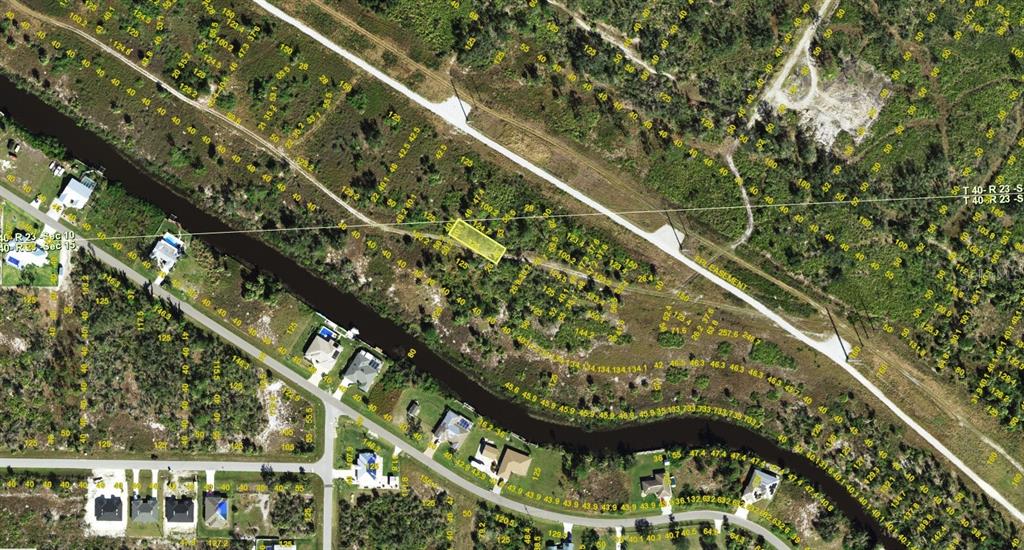 An aerial map view showing a rectangular plot of land highlighted in yellow — 1545 WAMPUM COURT, PUNTA GORDA, FL
