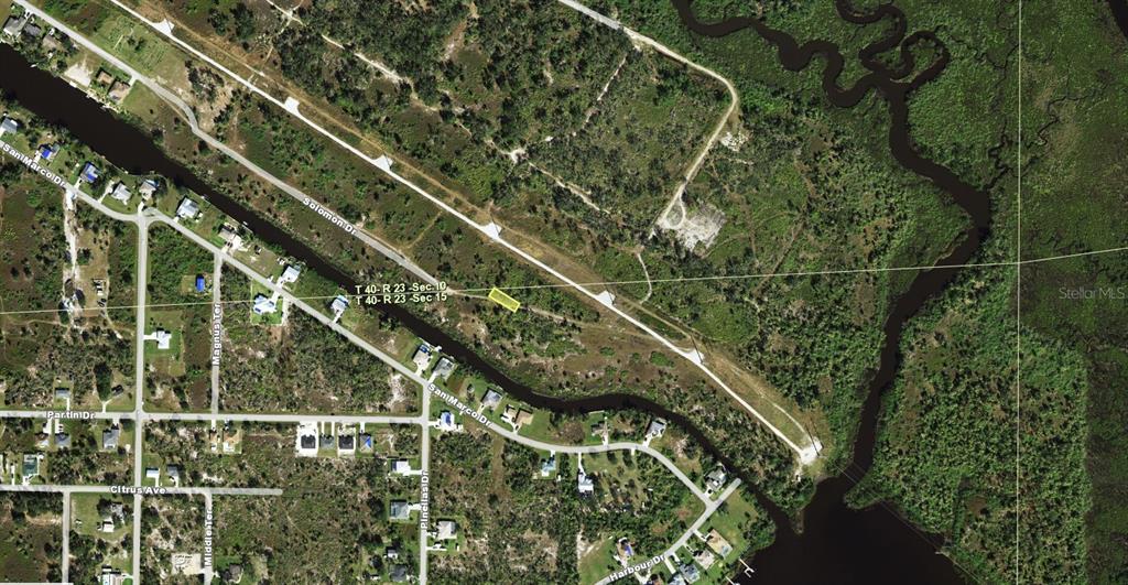 An aerial map view shows a highlighted vacant lot surrounded by undeveloped land and canals — 1545 WAMPUM COURT, PUNTA GORDA, FL