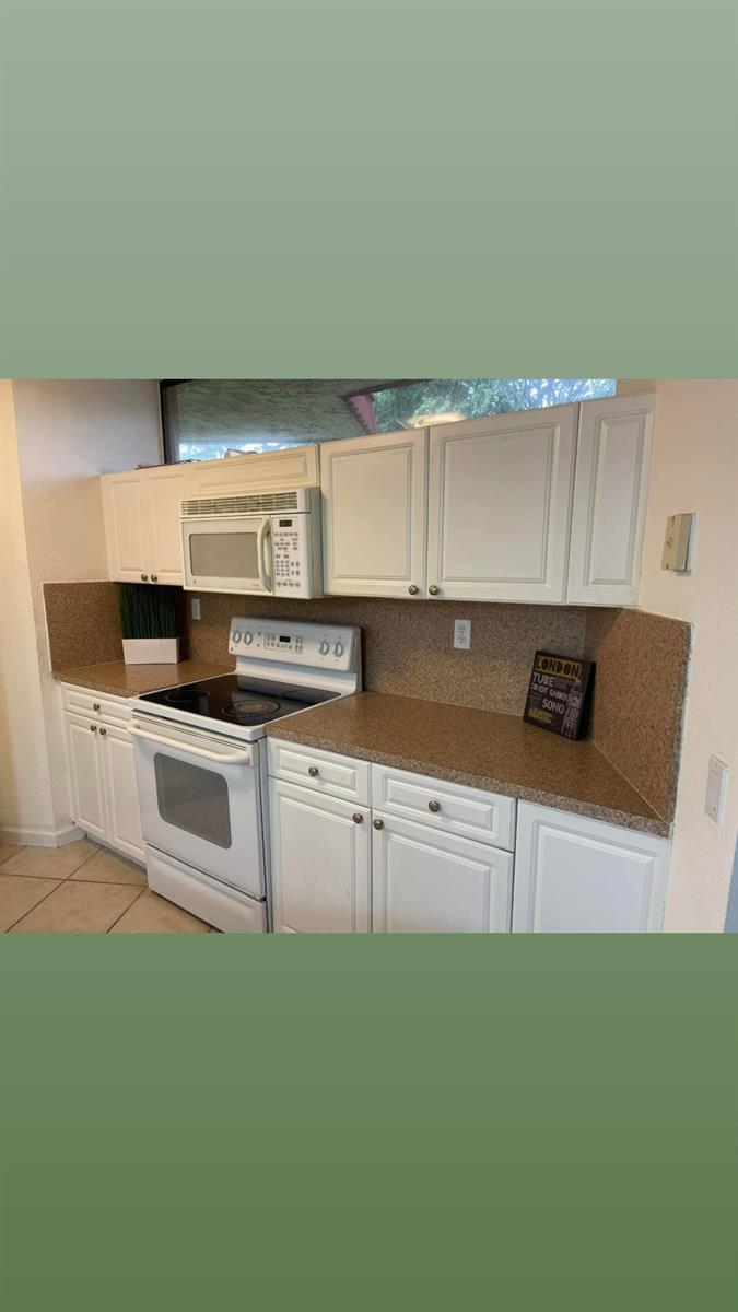 A kitchen with white cabinets, brown countertops, and white appliances — 8159 Severn Drive # A, Boca Raton FL 33433, BOCA RATON, FL