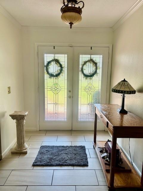 An entryway features a double glass door, a tile floor, a pedestal, and a console table — 2935 PLANTATION ROAD, WINTER HAVEN, FL