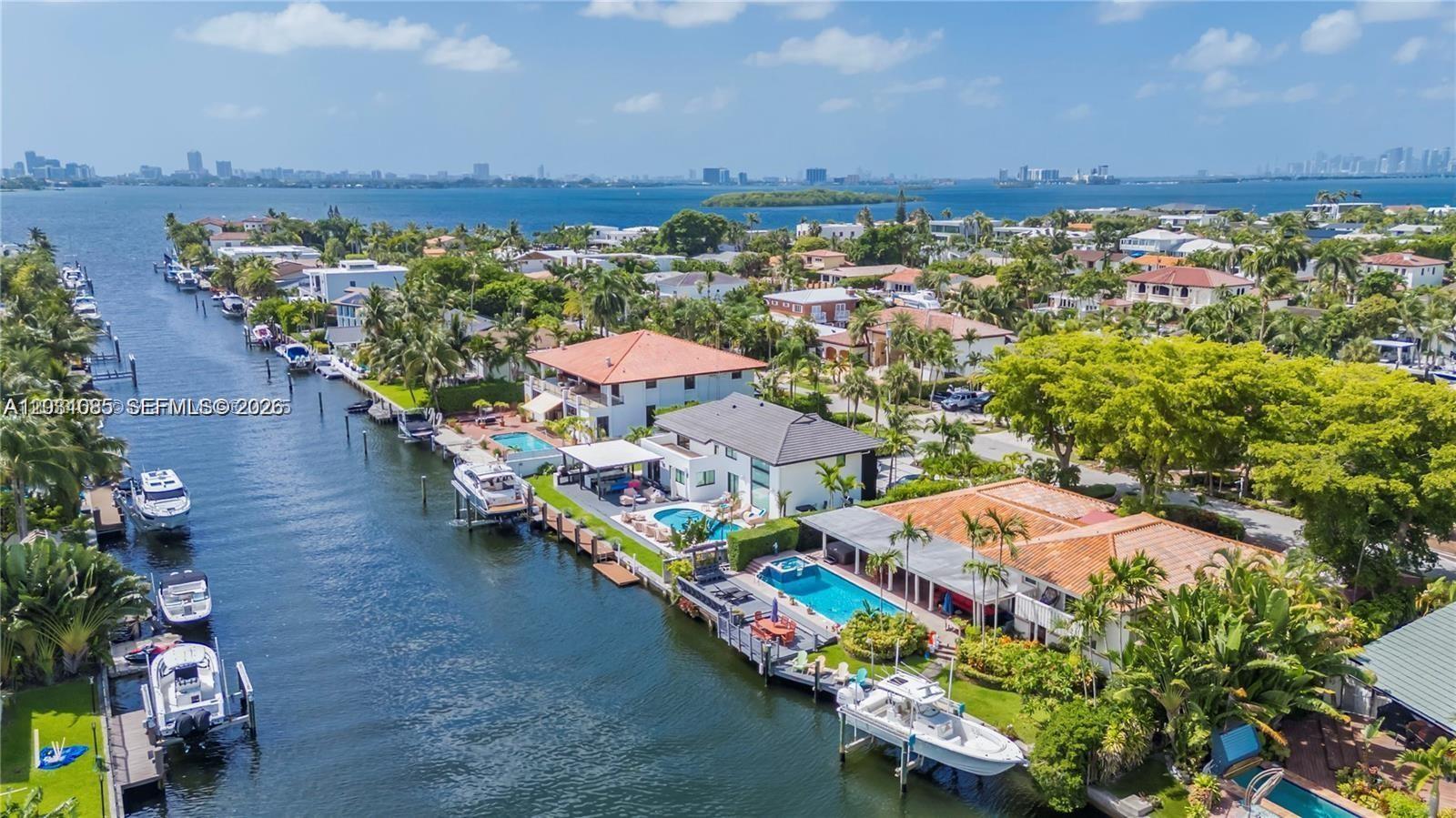 An aerial view shows waterfront homes with pools and private boat docks along a canal — 2015 NE 120th Rd, North Miami FL 33181, NORTH MIAMI, FL