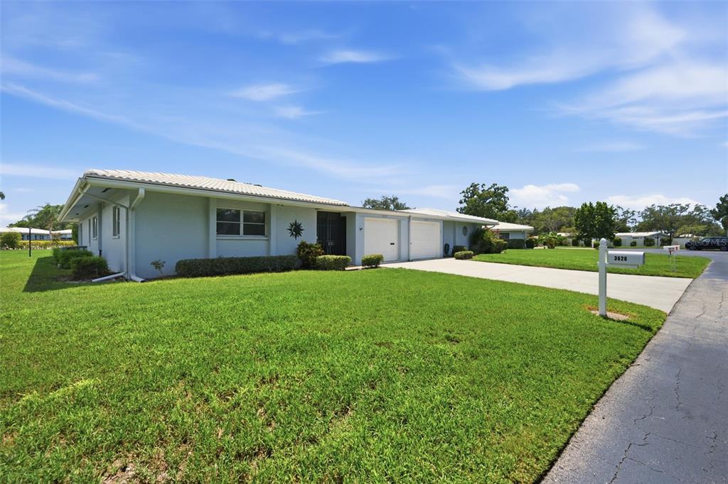 A light-colored single-story house with a two-car garage and a large front lawn — 3626 MEDFORD LANE UNIT 1537, SARASOTA, FL