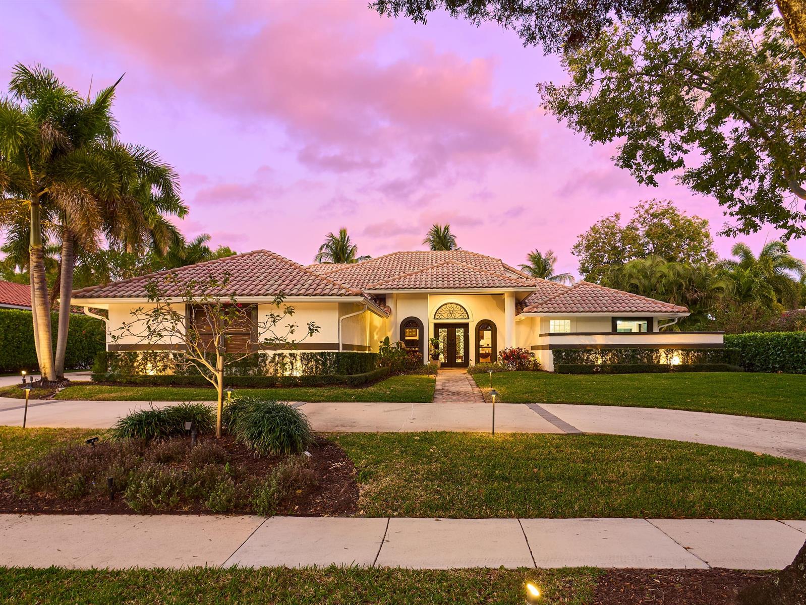 A single-story house with a tiled roof and a paved driveway at sunset — 3700 Embassy Drive, West Palm Beach FL 33401, WEST PALM BEACH, FL