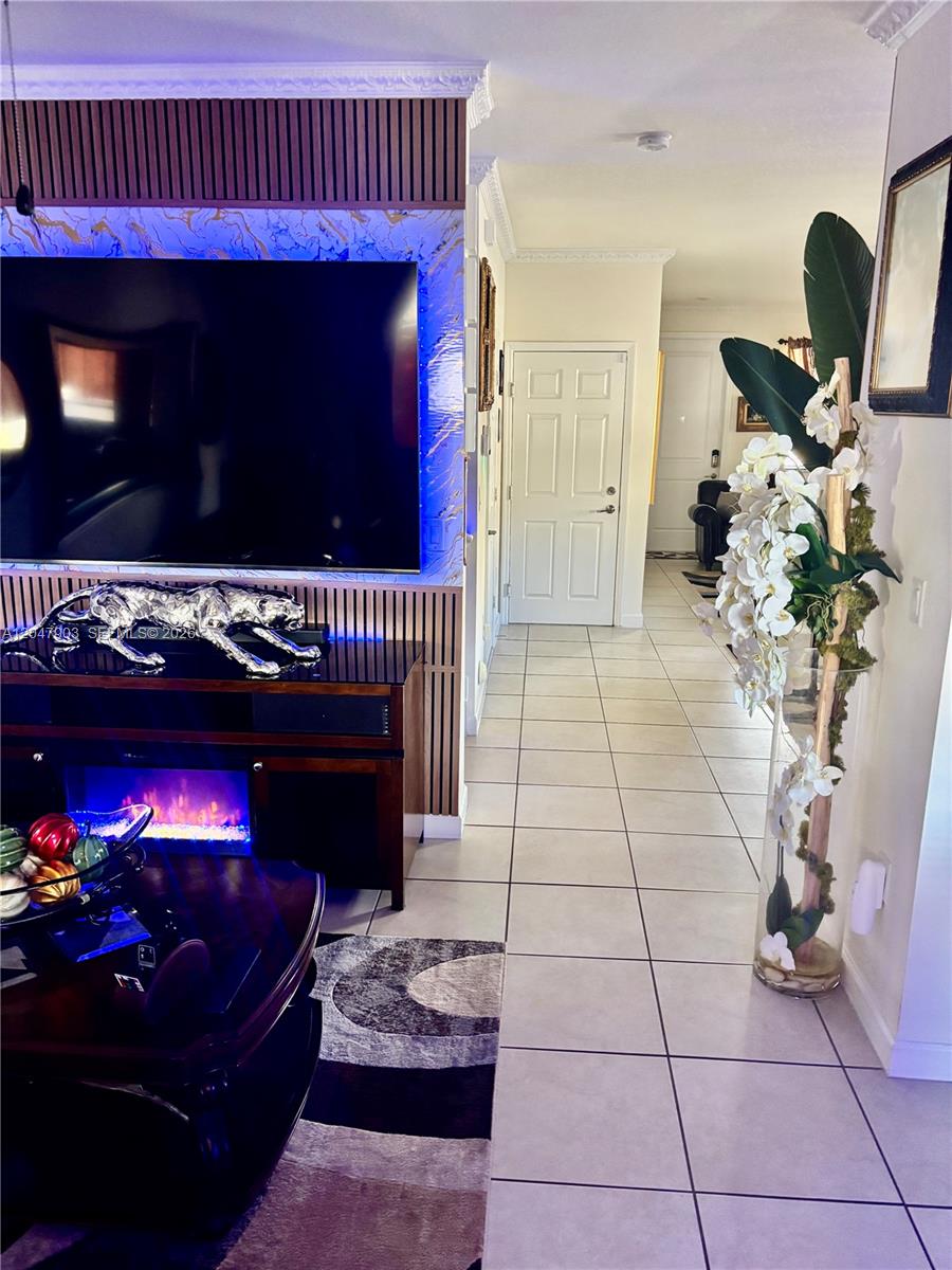 A two-story house exterior features a stone-veneer entryway, a dark garage door, and a paver driveway — 11406 SW 252nd Ter, Homestead FL 33032, HOMESTEAD, FL