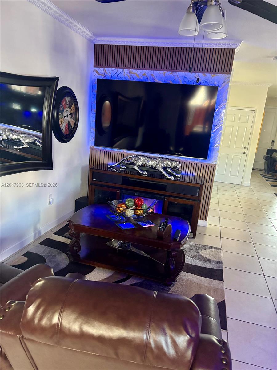 A two-story townhouse exterior features a stone facade, a dark garage door, and a brick driveway — 11406 SW 252nd Ter, Homestead FL 33032, HOMESTEAD, FL