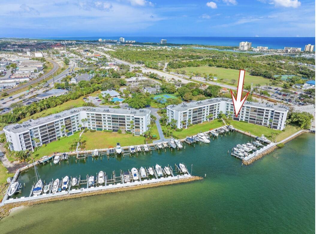 An aerial view shows two waterfront apartment buildings with a private boat marina — 1748 Jupiter Cove Drive # A, Jupiter FL 33469, JUPITER, FL