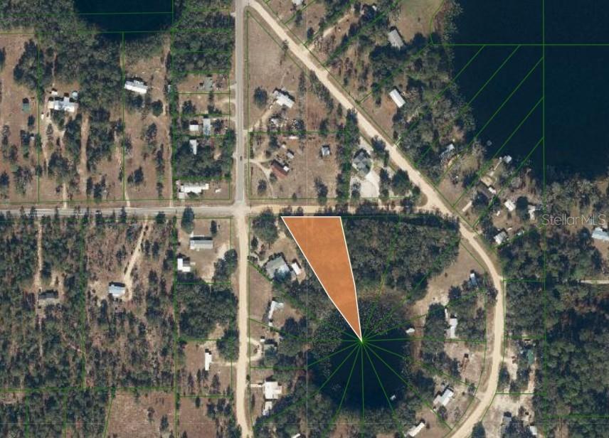 This aerial map shows a triangular parcel of land highlighted in orange near a lake — 503 64TH STREET, INTERLACHEN, FL