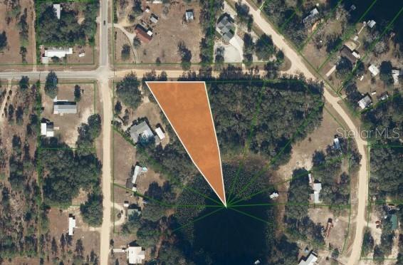An aerial map shows a triangular plot of land highlighted in orange next to a pond — 503 64TH STREET, INTERLACHEN, FL