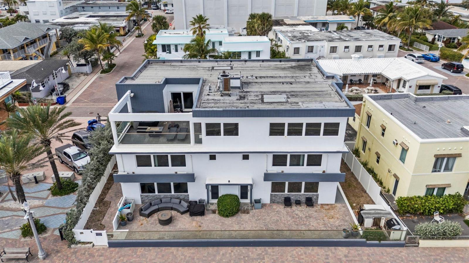 An aerial view of a three-story white building with a flat roof and patio — 2201 N Surf Road, Hollywood FL 33019, HOLLYWOOD, FL