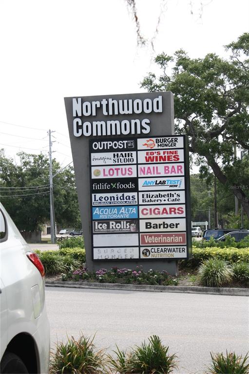 A tall, gray monument sign for Northwood Commons lists various businesses in a parking lot — 2454 MCMULLEN BOOTH ROAD UNIT 303, CLEARWATER, FL