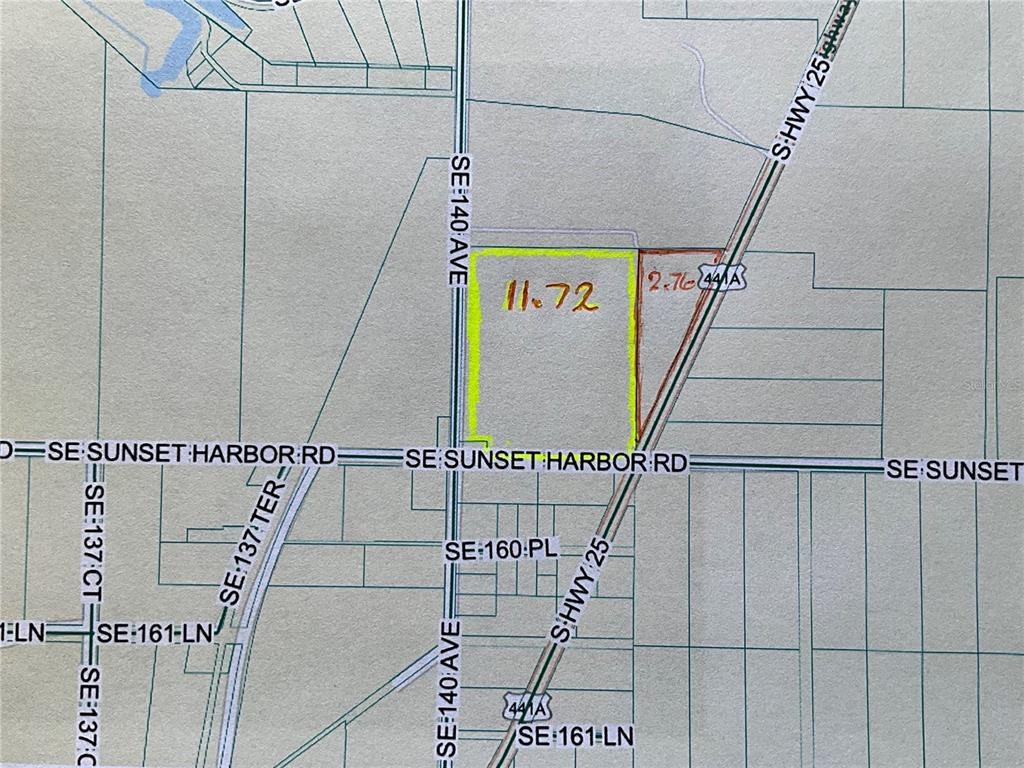 This is a map showing two adjacent parcels of land highlighted in yellow and red — SUNSET HARBOR RD, WEIRSDALE, FL