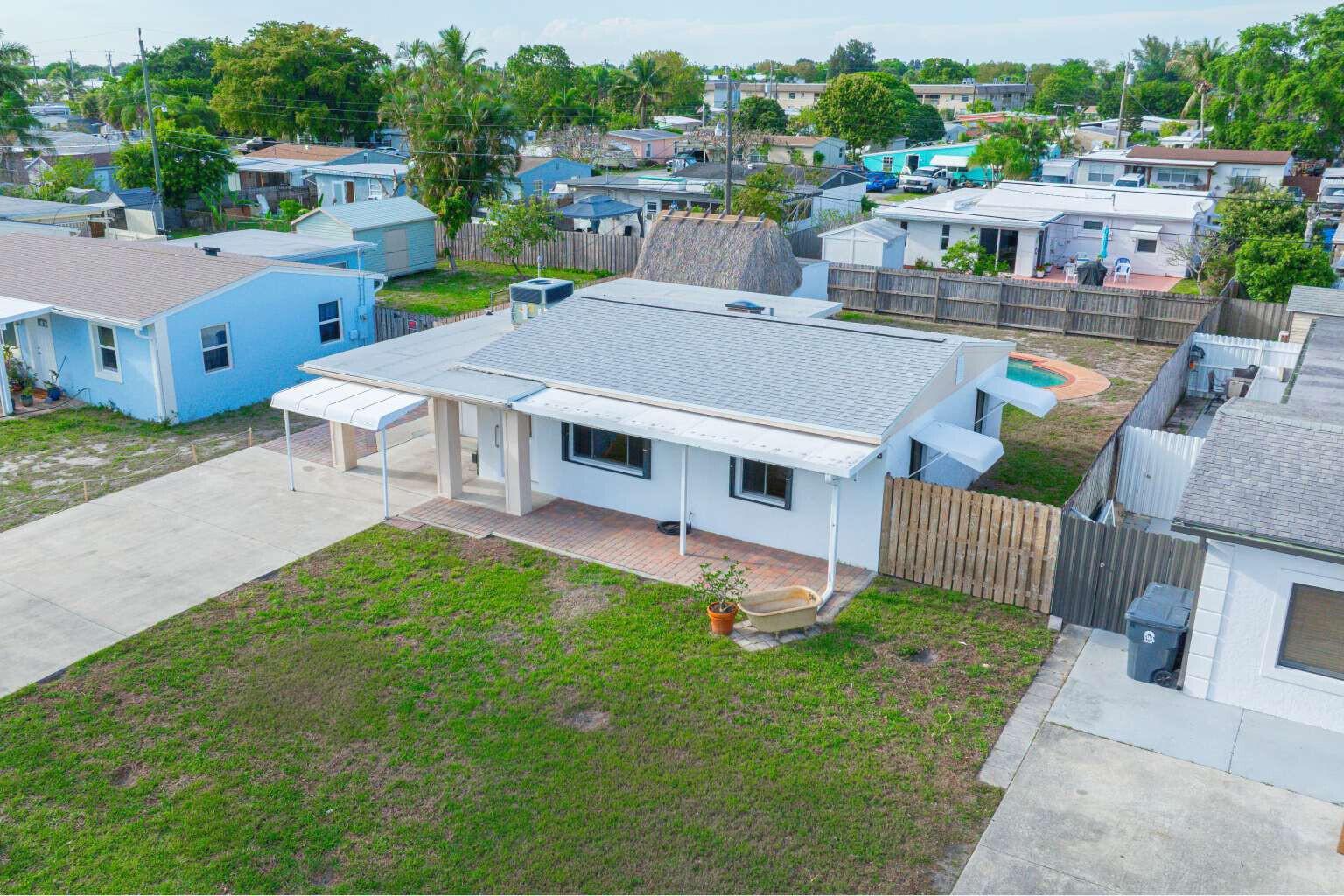 An aerial view of a white single-story house with a brick patio and pool — 3110 Scanlan Avenue, Lake Worth FL 33461, LAKE WORTH, FL