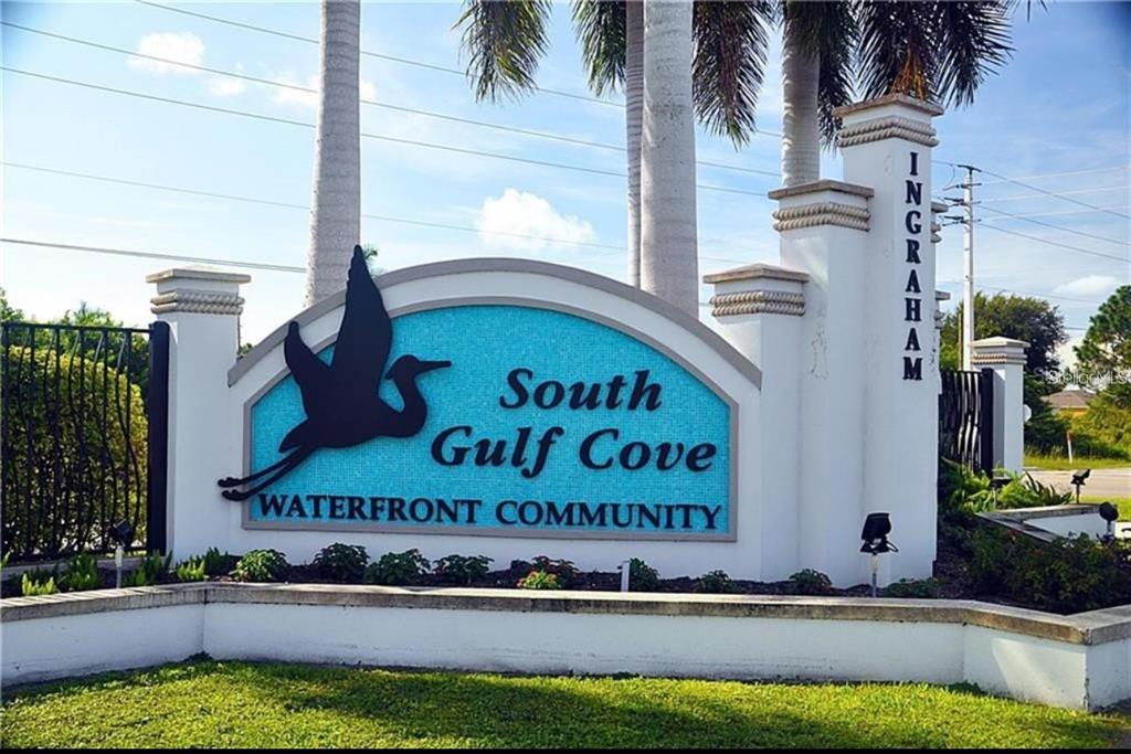 A stone monument sign displays the name South Gulf Cove Waterfront Community — 14407 MORRISTOWN AVENUE, PORT CHARLOTTE, FL